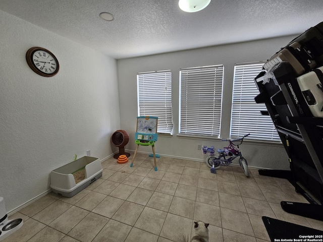 10518 Staggering, San Antonio, TX 78254 - game room featuring a textured ceiling, a textured wall, light tile patterned flooring, and baseboards