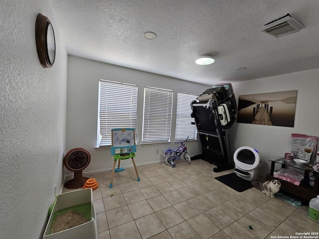 10518 Staggering, San Antonio, TX 78254 - exercise room featuring tile patterned flooring, a textured ceiling, and baseboards