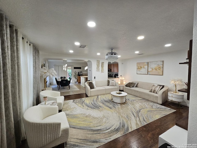 10518 Staggering, San Antonio, TX 78254 - living area featuring arched walkways, wood finished floors, recessed lighting, a chandelier, and a textured ceiling