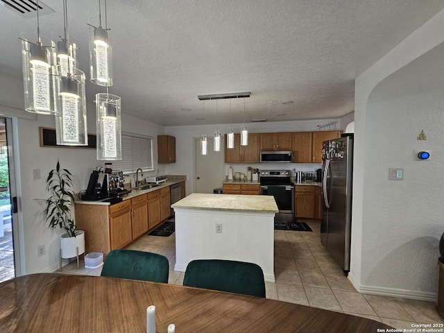 10518 Staggering, San Antonio, TX 78254 - kitchen with appliances with stainless steel finishes, a sink, light tile patterned floors, a textured ceiling, and a center island