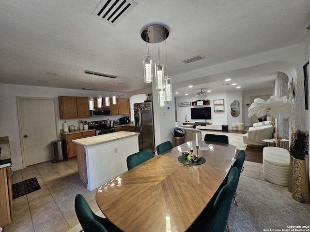 10518 Staggering, San Antonio, TX 78254 - dining area with a textured ceiling, arched walkways, recessed lighting, and light tile patterned flooring