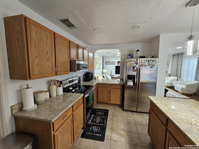 10518 Staggering, San Antonio, TX 78254 - kitchen with appliances with stainless steel finishes, arched walkways, brown cabinets, light tile patterned floors, and decorative light fixtures