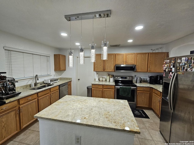10518 Staggering, San Antonio, TX 78254 - kitchen featuring stainless steel appliances, a center island, brown cabinetry, a sink, and recessed lighting