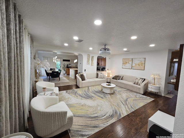 10518 Staggering, San Antonio, TX 78254 - living area with recessed lighting, wood finished floors, arched walkways, baseboards, and a textured ceiling