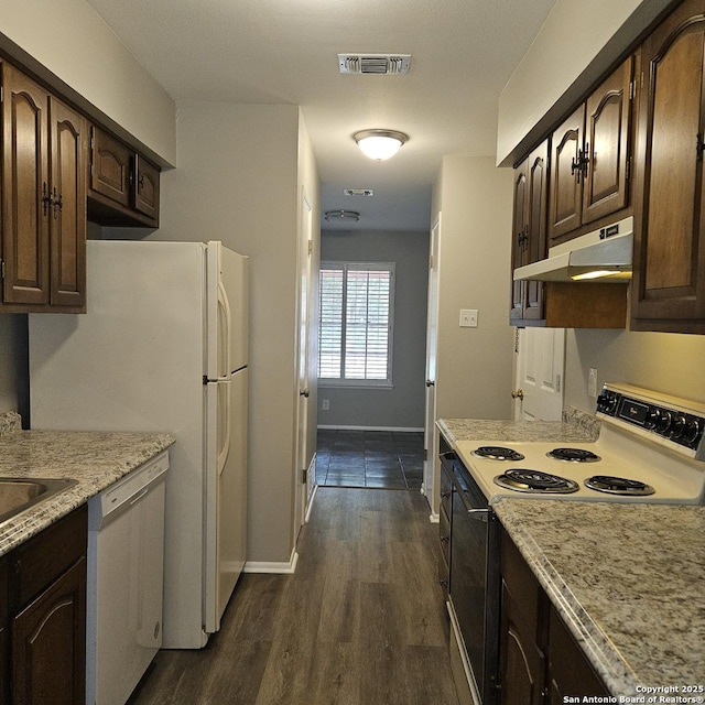 2915 Eisenhauer, San Antonio, TX 78209 - kitchen with white appliances, under cabinet range hood, dark brown cabinets, dark wood-type flooring, and baseboards