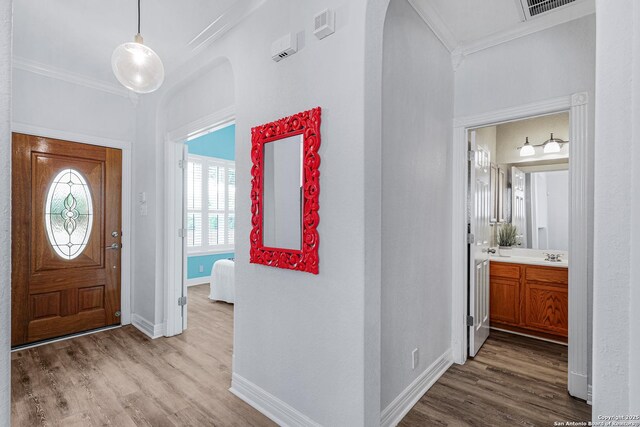 10907 Sangria Mist, San Antonio, TX 78249 - entryway featuring ornamental molding, wood finished floors, baseboards, and arched walkways