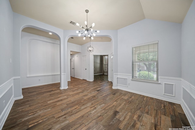 3615 Mill Mdw, San Antonio, TX 78247 - spare room featuring a chandelier, arched walkways, wood finished floors, vaulted ceiling, and wainscoting
