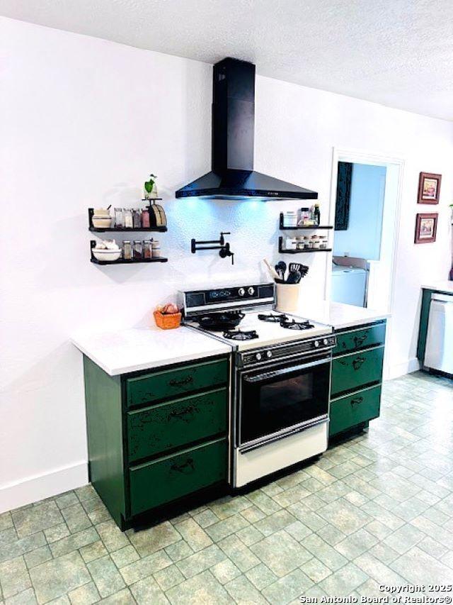 703 Mcdougal, San Antonio, TX 78223 - kitchen with green cabinetry, range with gas cooktop, wall chimney exhaust hood, dishwasher, and baseboards