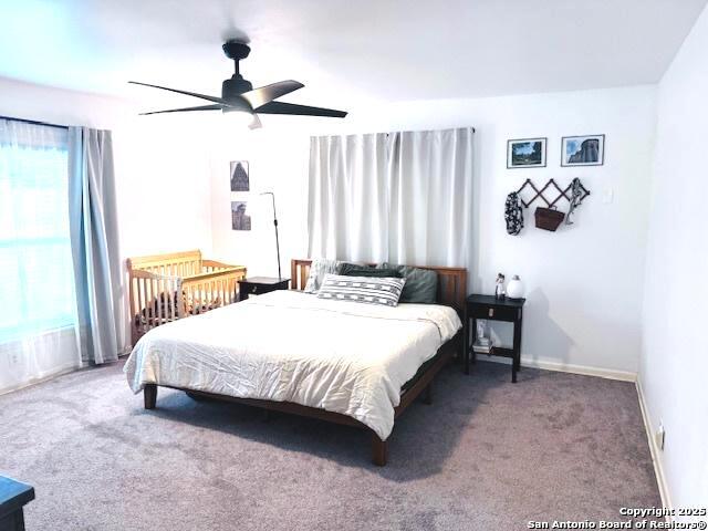 703 Mcdougal, San Antonio, TX 78223 - bedroom with carpet floors, baseboards, and a ceiling fan
