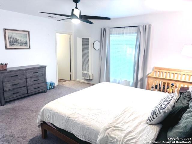 703 Mcdougal, San Antonio, TX 78223 - carpeted bedroom with a heating unit and ceiling fan