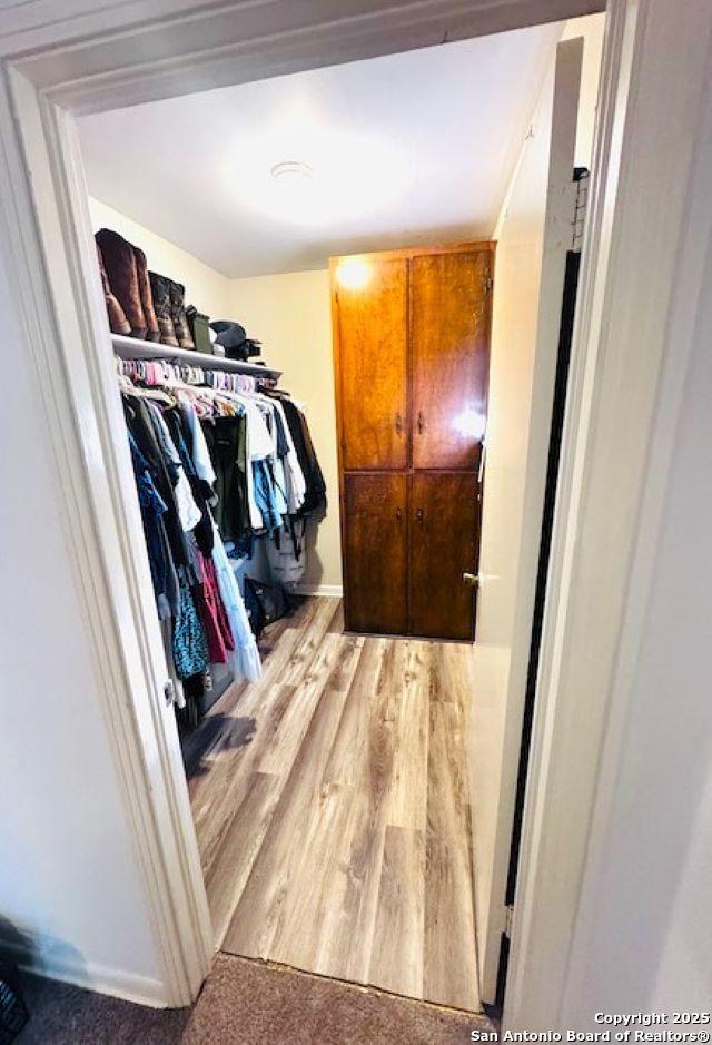 703 Mcdougal, San Antonio, TX 78223 - walk in closet with light wood finished floors