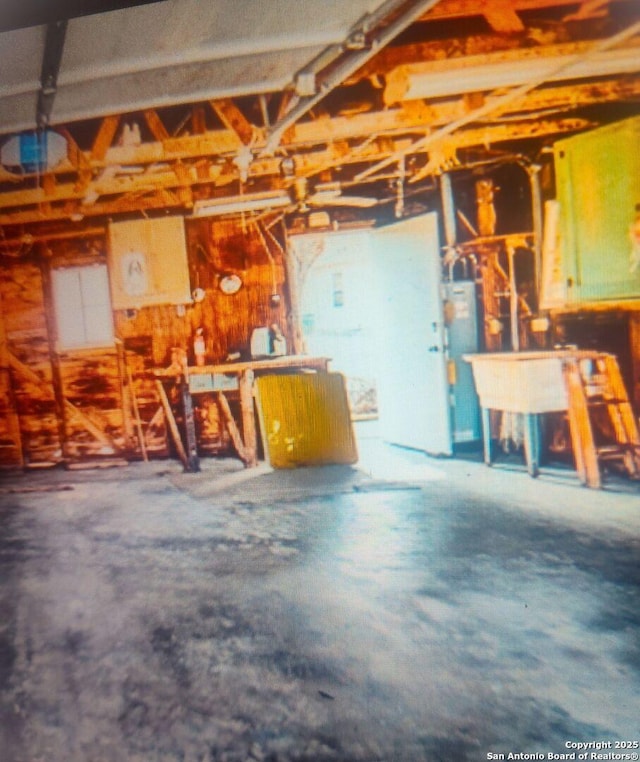 703 Mcdougal, San Antonio, TX 78223 - garage with a workshop area, water heater, and a garage door opener