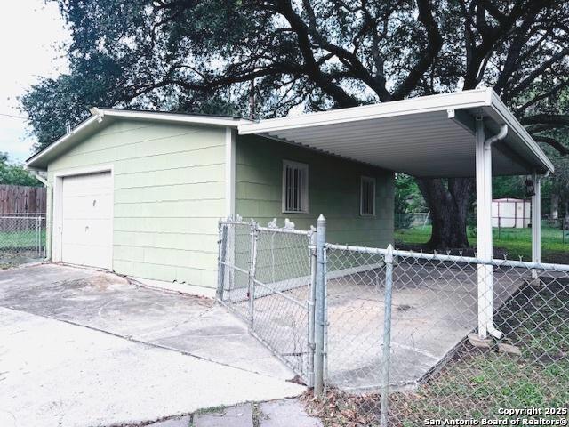 703 Mcdougal, San Antonio, TX 78223 - exterior space featuring driveway, a carport, and a garage