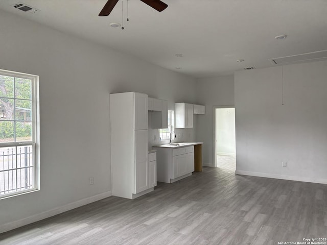 151 Cornell, San Antonio, TX 78201 - kitchen featuring a sink, light wood-style floors, ceiling fan, and baseboards