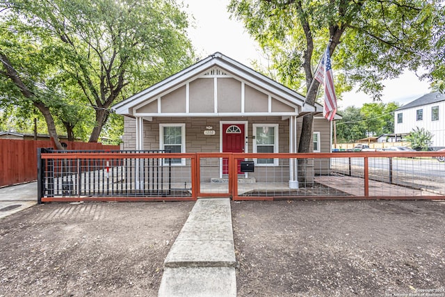 1202 N Center, San Antonio, TX 78202 - view of front of house featuring covered porch, a fenced front yard, and stone siding