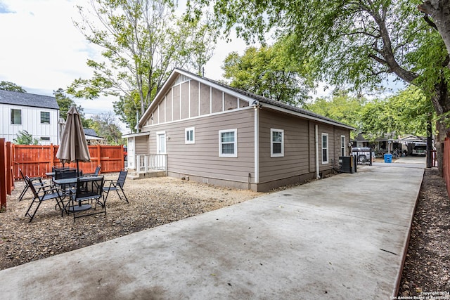 1202 N Center, San Antonio, TX 78202 - view of side of property featuring board and batten siding, a patio, and driveway