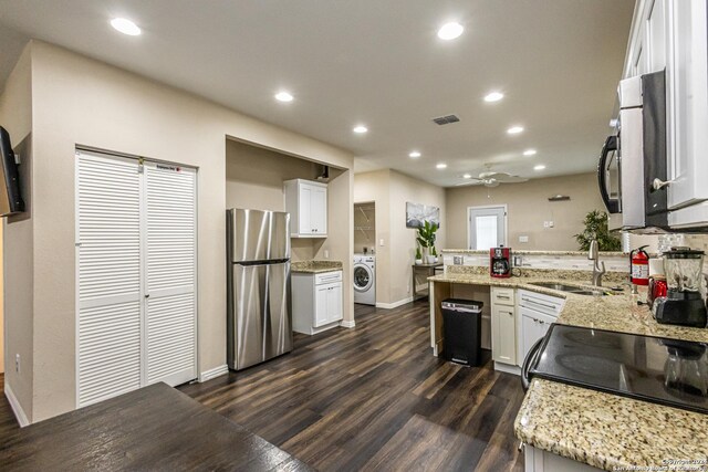 1202 N Center, San Antonio, TX 78202 - kitchen featuring freestanding refrigerator, washer / clothes dryer, a sink, a peninsula, and white cabinets