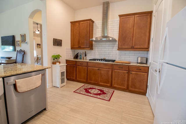 4634 Makayla Cross, San Antonio, TX 78261 - kitchen featuring freestanding refrigerator, wall chimney range hood, dishwasher, brown cabinetry, and decorative backsplash