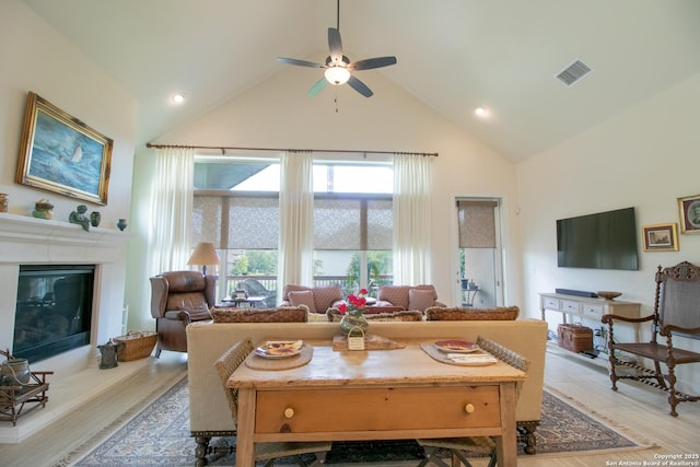 4634 Makayla Cross, San Antonio, TX 78261 - living area with high vaulted ceiling, ceiling fan, light wood-style flooring, a glass covered fireplace, and recessed lighting