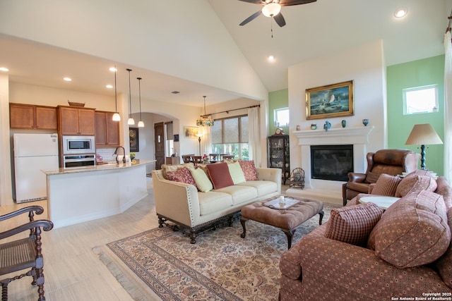 4634 Makayla Cross, San Antonio, TX 78261 - living area featuring recessed lighting, ceiling fan, a glass covered fireplace, high vaulted ceiling, and arched walkways