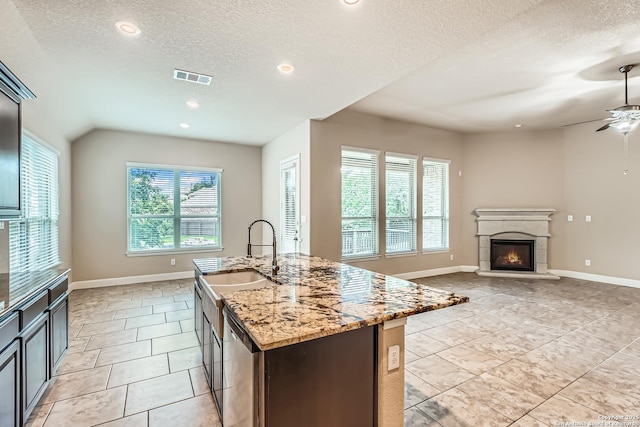 32241 Tamarind, Bulverde, TX 78163 - kitchen featuring a sink, stainless steel dishwasher, a textured ceiling, ceiling fan, and light stone countertops