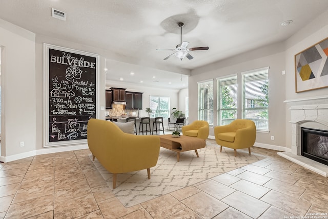 32241 Tamarind, Bulverde, TX 78163 - living room with ceiling fan, a glass covered fireplace, baseboards, and recessed lighting
