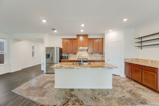 5245 Nature Path, Schertz, TX 78154 - kitchen with stainless steel appliances, a sink, ornamental molding, a center island with sink, and under cabinet range hood