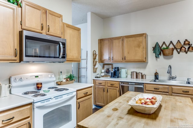 9515 Wicklow, San Antonio, TX 78250 - kitchen featuring stainless steel appliances, a sink, wood counters, and a textured ceiling