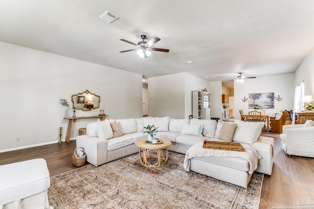 9515 Wicklow, San Antonio, TX 78250 - living area with ceiling fan, wood finished floors, a textured ceiling, and baseboards