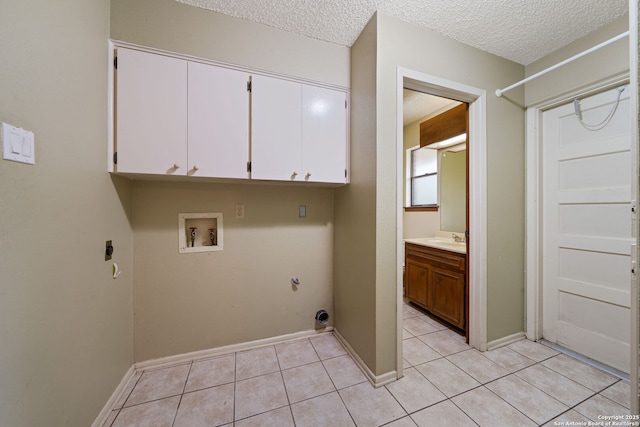 2822 Low Oak, San Antonio, TX 78232 - washroom with gas dryer hookup, electric dryer hookup, washer hookup, cabinet space, and light tile patterned floors
