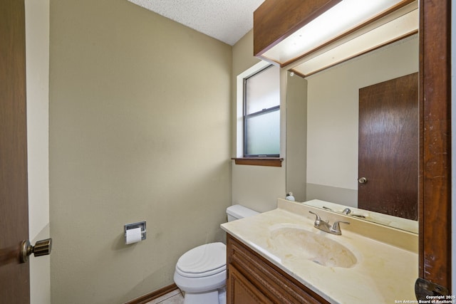 2822 Low Oak, San Antonio, TX 78232 - bathroom featuring toilet, vanity, baseboards, and a textured ceiling