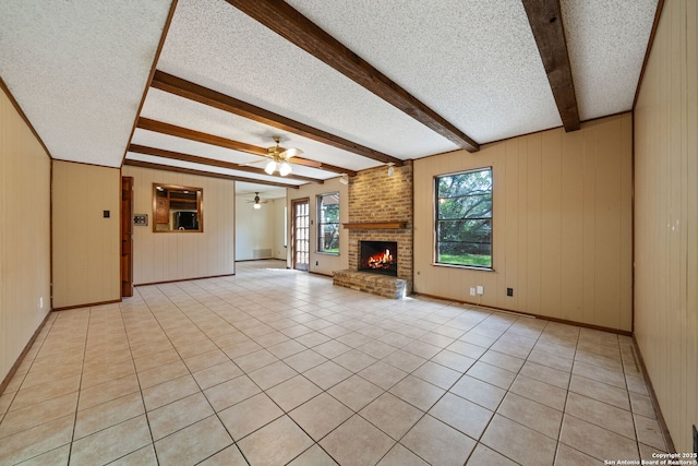 2822 Low Oak, San Antonio, TX 78232 - unfurnished living room with a textured ceiling, a fireplace, beam ceiling, baseboards, and ceiling fan