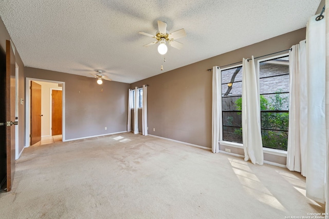 2822 Low Oak, San Antonio, TX 78232 - spare room featuring ceiling fan, a textured ceiling, baseboards, and light colored carpet