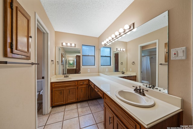 2822 Low Oak, San Antonio, TX 78232 - bathroom with toilet, double vanity, a textured ceiling, tile patterned flooring, and curtained shower