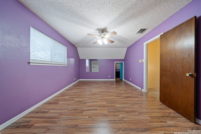 2822 Low Oak, San Antonio, TX 78232 - unfurnished room featuring ceiling fan, wood finished floors, a textured ceiling, lofted ceiling, and baseboards