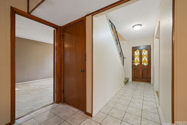2822 Low Oak, San Antonio, TX 78232 - hall with a textured ceiling, light tile patterned flooring, light carpet, baseboards, and stairs