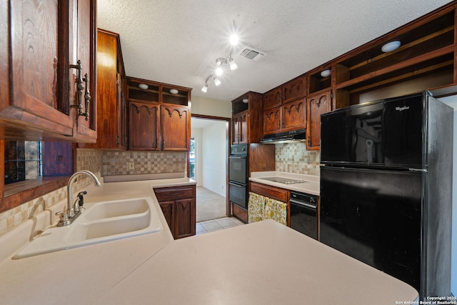 2822 Low Oak, San Antonio, TX 78232 - kitchen featuring black appliances, a sink, under cabinet range hood, decorative backsplash, and light countertops