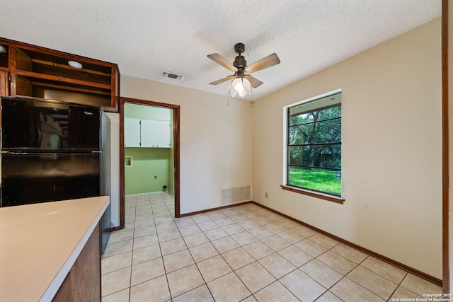 2822 Low Oak, San Antonio, TX 78232 - kitchen with ceiling fan, a textured ceiling, light countertops, light tile patterned floors, and baseboards