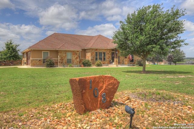 108 Westfield Ln, Vernia, TX 78121 - ranch-style house with stone siding, a front yard, and stucco siding