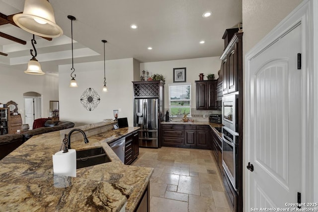 108 Westfield Ln, Vernia, TX 78121 - kitchen with stainless steel appliances, a sink, stone tile flooring, dark brown cabinets, and recessed lighting