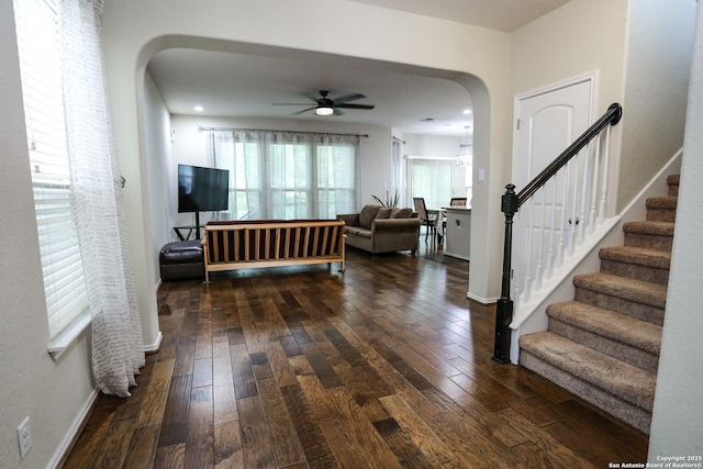 7239 Summer Way, San Antonio, TX 78240 - living area with arched walkways, a ceiling fan, dark wood-style floors, and stairway