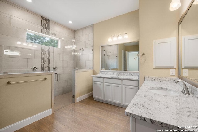 147 Bedingfeld, Shavano Park, TX 78231 - bathroom with a shower stall, wood finished floors, and two vanities