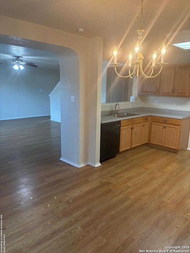 1230 Range Fld, San Antonio, TX 78245 - kitchen with black dishwasher, a sink, wood finished floors, a chandelier, and light countertops
