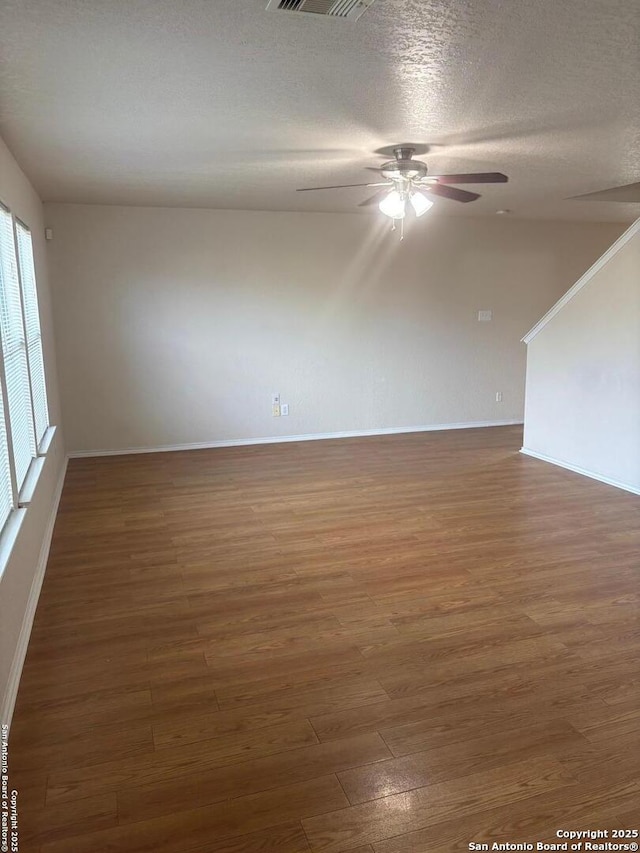 1230 Range Fld, San Antonio, TX 78245 - spare room featuring a ceiling fan, wood finished floors, baseboards, and a textured ceiling
