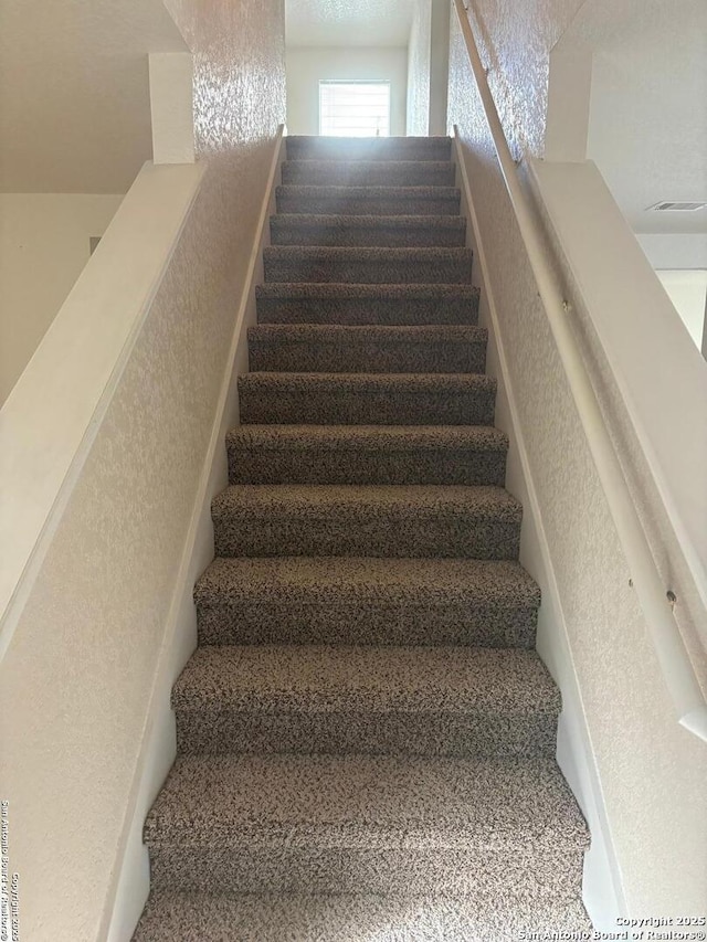 1230 Range Fld, San Antonio, TX 78245 - stairway featuring a textured wall