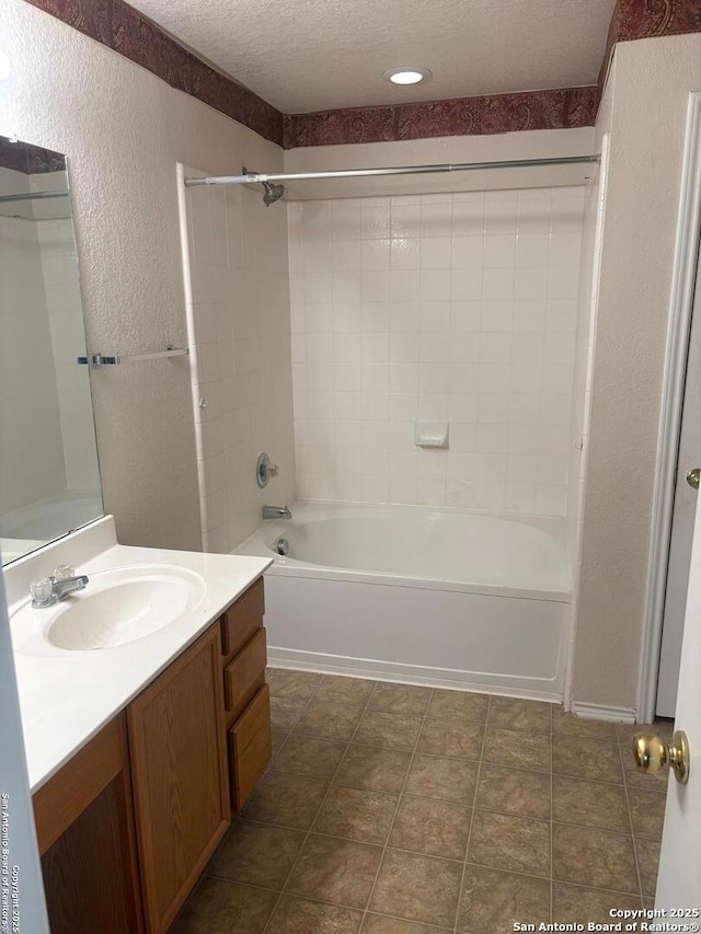 1230 Range Fld, San Antonio, TX 78245 - bathroom featuring a textured wall, vanity,  shower combination, and a textured ceiling