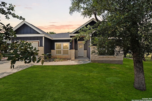 546 Indian Scout, Spring Branch, TX 78070 - view of front facade featuring a garage, board and batten siding, a front lawn, and driveway