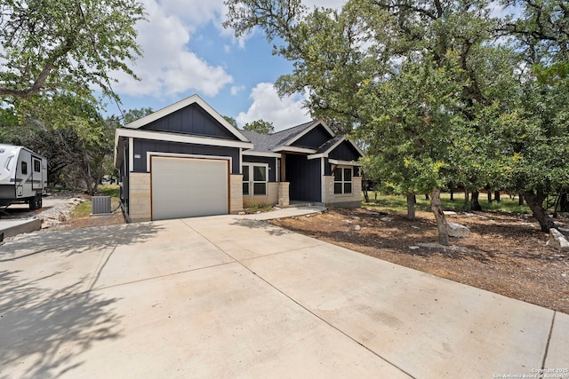 546 Indian Scout, Spring Branch, TX 78070 - view of front of home featuring an attached garage, concrete driveway, cooling unit, and board and batten siding