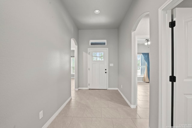546 Indian Scout, Spring Branch, TX 78070 - foyer with arched walkways, light tile patterned floors, baseboards, and a ceiling fan