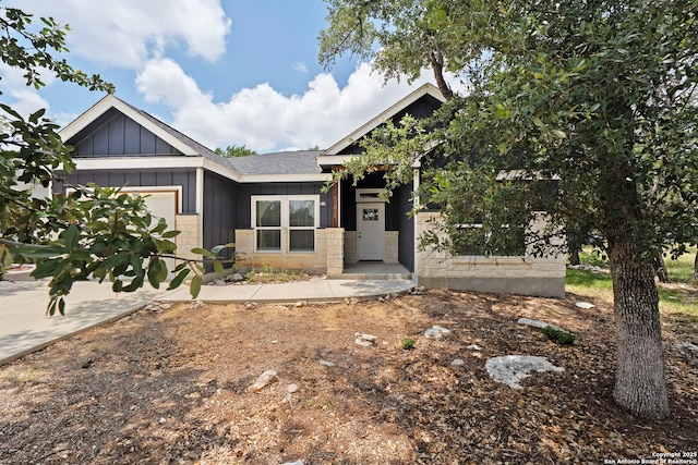 546 Indian Scout, Spring Branch, TX 78070 - view of front facade featuring a garage, board and batten siding, and a shingled roof